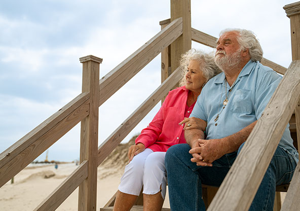 Linda sits with her husband overlooking the water in Corpus Christi. She had breast cancer and CHRISTUS Health diagnosed and treated her in Corpus Christi.