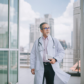 An Asian male doctor outside