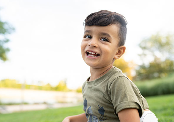 A smiling boy in the park